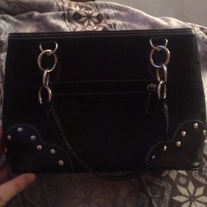 This is a Couch purse, black with two main pockets